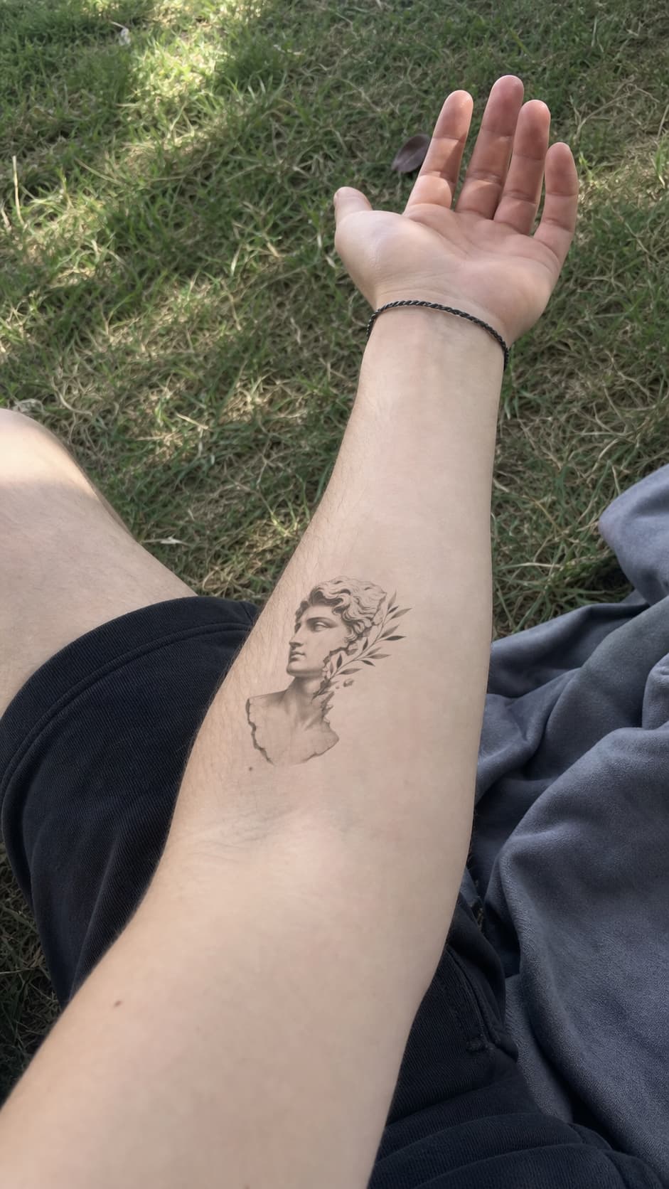 Classical sculpture tattoo previewed on a real forearm photo — virtual tattoo try-on