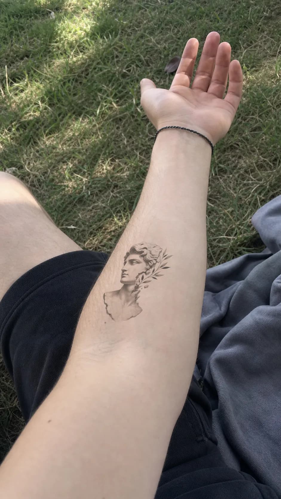 Classical sculpture tattoo previewed on a forearm — virtual tattoo try-on